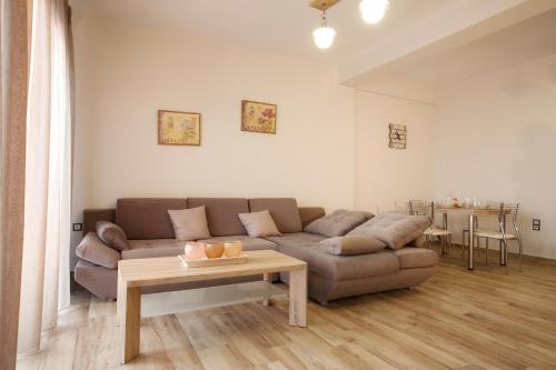 a living room with a couch and a table at Petra Thea in Kalamata