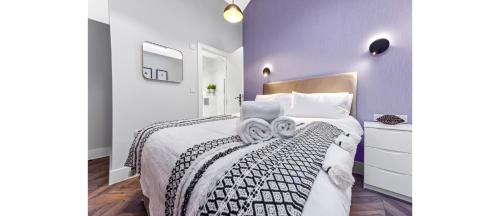 a bedroom with a bed with two towels on it at Cozy 1 BD Flat in London! in Romford