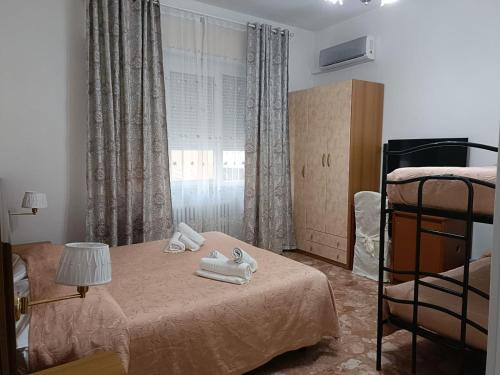 a bedroom with a bed with towels on it at Domus Cesena in Cesena