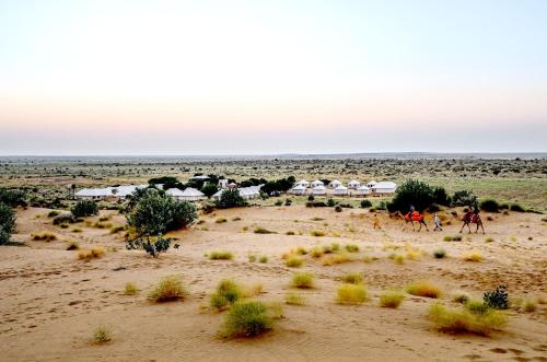 a group of people riding horses in the desert at Prince Desert Camp in Sām