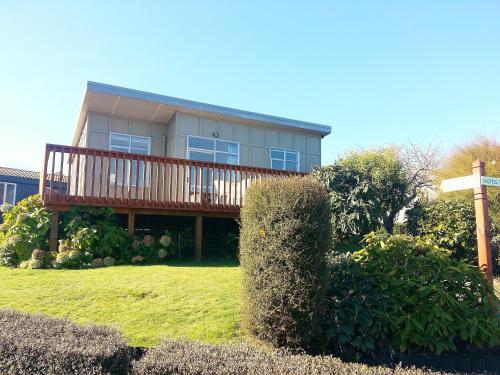 a large house with a deck on top of a yard at Taupo Debretts Spa Resort in Taupo