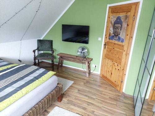 a bedroom with a bed and a door with a picture of a man at Schöne voll ausgestattete Ferienwohnung in Havixbeck