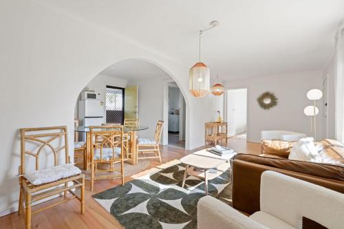 a living room with a couch and a table at Komune II in Cowes