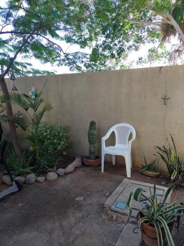 a white chair sitting in front of a wall at Lot # 7 ~ Large, Energetic Baja House in Guaymas