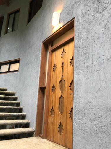 a wooden door on the side of a building with stairs at Frondavista San Pancho in San Francisco