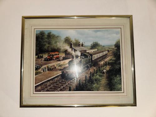 a framed painting of a train on the tracks at Guest House Nikol in Sherborne Saint John