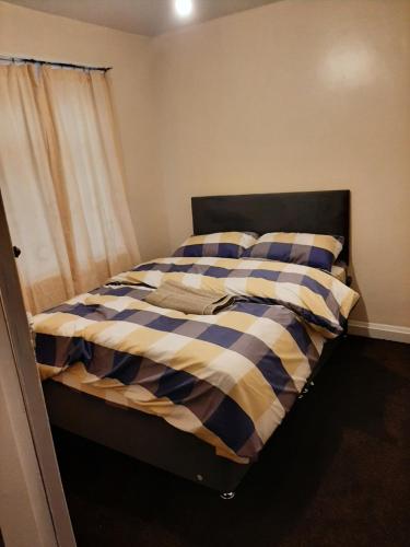 1 cama con manta a cuadros en un dormitorio en Galore De Hovingham, en Middlesbrough
