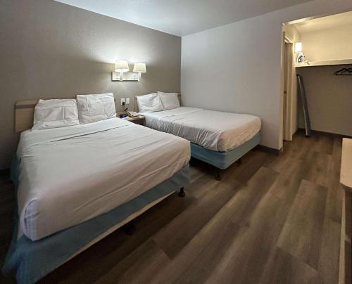 a hotel room with two beds in a room at Studio 6 Lubbock, TX in Lubbock