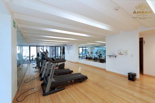 a gym with treadmills and ellipticals in a room at Ámbar Suite Room / lujo y confort únicos in Quito