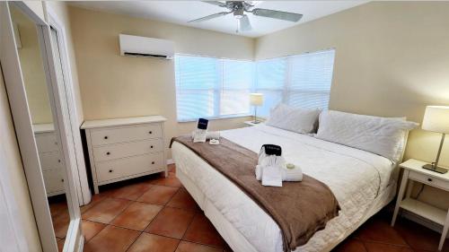 a bedroom with a large bed with two towels on it at By the Beach Rentals in Clearwater Beach