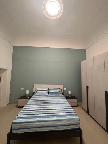 a bedroom with a large bed with two night stands at La Casa di Pina in Pozzallo