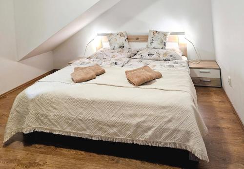 a bedroom with a large bed with two pillows on it at Janka Apartment in Bratislava