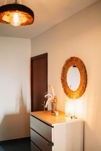 a room with a mirror on the wall and a dresser at Quinta da Quintã AL in São Pedro do Sul