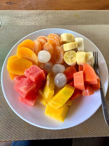 a plate of fruits and vegetables on a table at Rainbow Lodge in Koh Kong