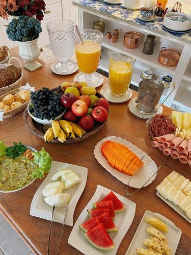 a table topped with lots of different types of food at La Belle Provence in Itaipava