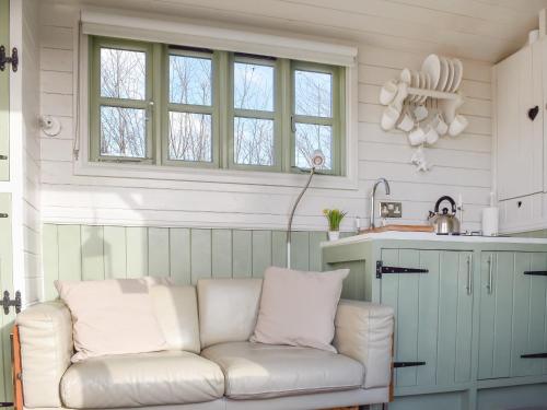 a living room with a white couch in a kitchen at The Little Lodge in Monmouth