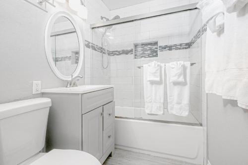 a white bathroom with a sink and a mirror at Stunning Ocean Views - Recently Renovated Home & Warm Sunsets in San Diego
