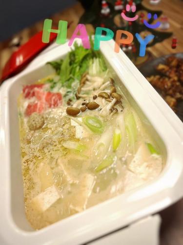 a styrofoam container of soup with vegetables and nuts at South coast Chikura in Chikura