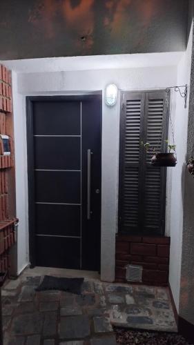 a black door with a window and a door with at Dúplex VIGUS in San Salvador de Jujuy