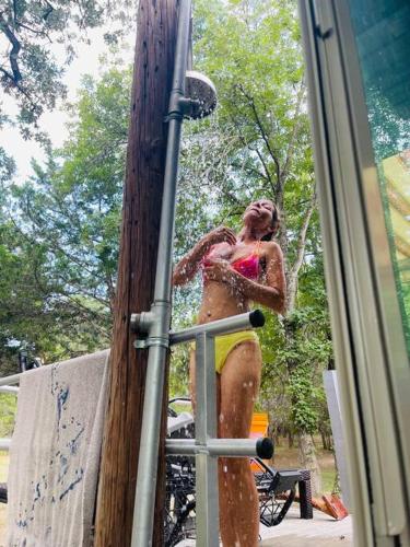 a woman is standing in a water fountain at Bastrop Tiny Disc Golf Retreat in Bastrop