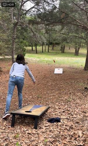 a woman standing on a table in a park at Bastrop Tiny Disc Golf Retreat in Bastrop