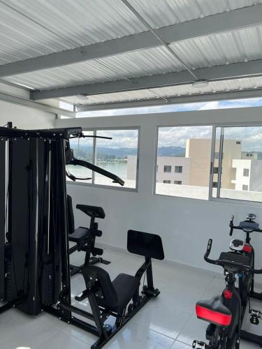 a gym with several exercise bikes in a room with windows at Rústico 804 Lago Sochagota in Paipa