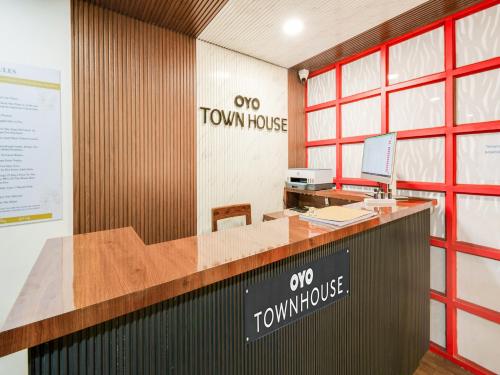 an office with a desk and a townhouse sign at Townhouse Hotel Rio in Hyderabad
