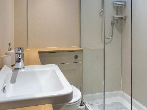 a bathroom with a sink and a shower at The Barn in Dalmally