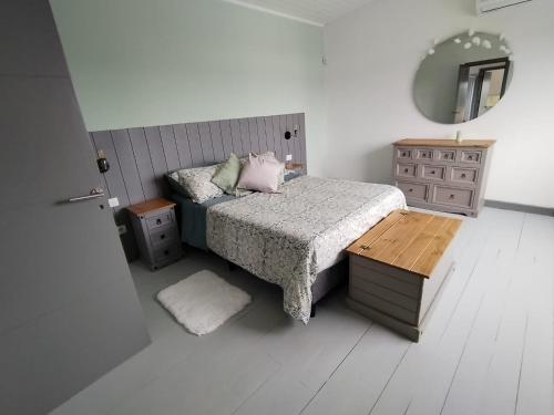 a bedroom with a bed and a table and a mirror at Casa de playa en jose ignacio uruguay. in José Ignacio