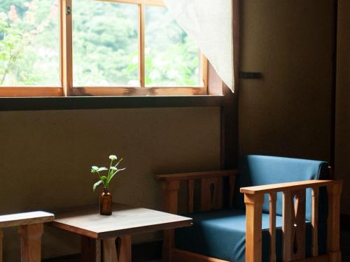 a room with a table and a chair and a window at RITA Izumo Sagiura in Izumo