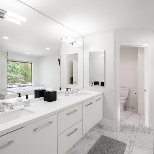 a white bathroom with two sinks and a toilet at Multi-Million Dollar Luxury Estate, Heated Pool, City Views in Phoenix