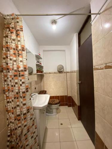 a small bathroom with a toilet and a sink at Casa Katya Cusco in Cusco