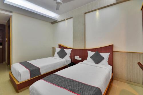a hotel room with two beds in a room at Townhouse 1307 Coastal Grand Hotels and Resorts in Coimbatore