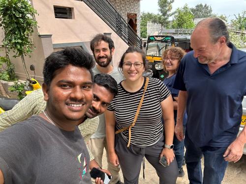 a group of people posing for a picture at Lee home stay in Hampi