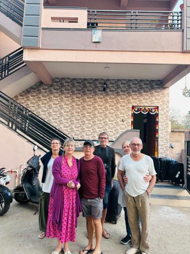 a group of people standing in front of a building at Lee home stay in Hampi