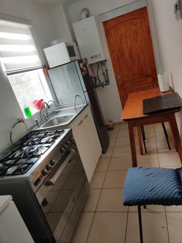 a kitchen with a stove and a sink at casa independiente por días en Punta Arenas in Punta Arenas