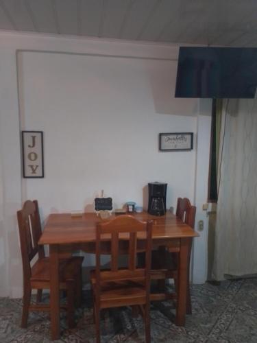 mesa de comedor con sillas y microondas en Habitacion en Bijagua, en Bijagua