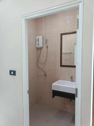 a bathroom with a sink and a mirror and a shower at Sj House Hotel Aonang in Ban Khlong Haeng
