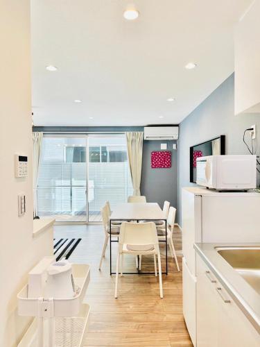 a kitchen and dining room with a table and chairs at Megu Fuji Plus in Fujiyoshida