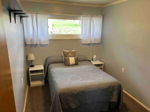 een kleine slaapkamer met een bed en een raam bij Barbee Chain Lake Access! 3 Bedroom Cozy Cottage in North Webster