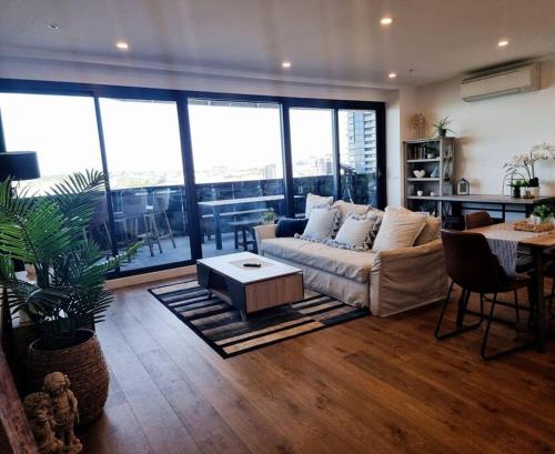 a living room with a couch and a table at 2 Bedrooms Aptmt with Ocean View in Geelong
