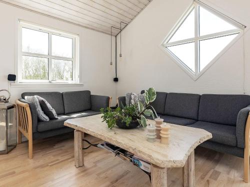 a living room with a couch and a table at 8 person holiday home in Hirtshals in Hirtshals