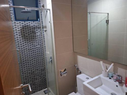 a bathroom with a shower and a toilet and a sink at Sweet Home in Kuala Lumpur