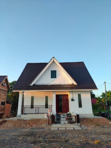 a small white house with a black roof at Homestay Midan Alor Setar in Alor Setar