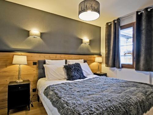 een slaapkamer met een bed, 2 lampen en een raam bij Appartement Huez, 2 pièces, 2 personnes - FR-1-645-60 in Huez