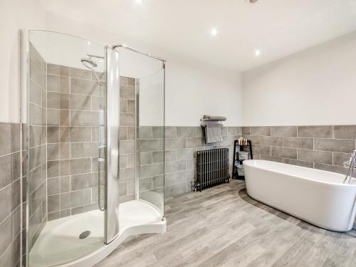 a bathroom with a bath tub and a shower at Binchester Crag Farm in Bishop Auckland