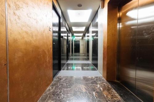 a hallway of an office building with a hallway at MAXX HOTEL MAKATI by MAXIHOME LAND in Manila