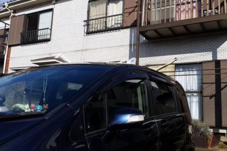 a blue car parked in front of a building at Mason 2 ,direct to Disney,Narita AP, Haneda AP,Asakusa,Sky Tree Tower, Ueno Ueno in Kamagaya