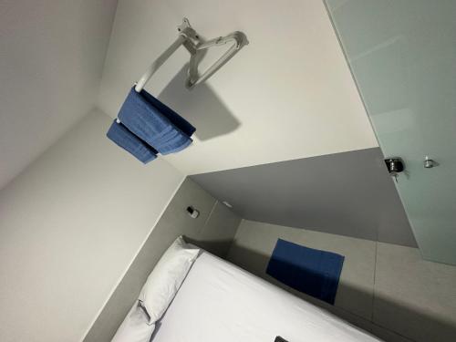 een kleine kamer met een bed en een wastafel bij Quarto privativo com banheiro compartilhado em Pousada recém construída,a 500mts do pátio do forró in Caruaru