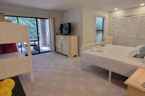 a bedroom with a bed and a television in it at 164 High Hammock VLG in Seabrook Island